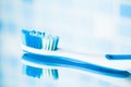 Toothbrush on blue tile background with mirror reflection