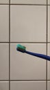 a toothbrush with blue toothpaste on a white tile background Royalty Free Stock Photo