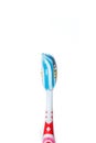Toothbrush with blue two color toothpaste on light surface Royalty Free Stock Photo