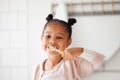 Toothbrush, brushing teeth and child in a home bathroom for dental health and wellness. Face of african girl kid Royalty Free Stock Photo