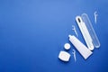 Toothbrush in a case, toothpaste, toothpicks and dental floss with space for text on a blue background. Dentistry and healthcare