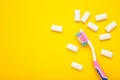 Toothbrush and chewing gums on yellow background. Minimal concept. Space for text Royalty Free Stock Photo