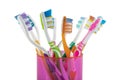 Toothbrush, toothbrush close-up. Set of toothbrushes in pink glass bowl on white background. Concept toothbrush selection, plastic Royalty Free Stock Photo