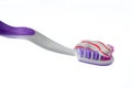 Toothbrush covered by toothpaste isolated on white Royalty Free Stock Photo