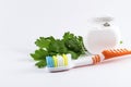 Toothbrush and dental floss on white background