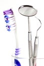 Toothbrush and Dental mirror - explorer in glass Royalty Free Stock Photo