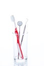 Toothbrush and Dental mirror - explorer in glass Royalty Free Stock Photo