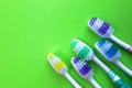 Five toothbrushes lie on a green background Royalty Free Stock Photo