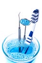 Toothbrush and dentist tools in glass isolated on white Royalty Free Stock Photo