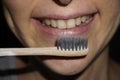 Toothbrush in front of the smiling female's face