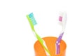 A toothbrush in a glass cup isolated on a white background. Care of teeth. Teeth cleaning. Beauty and health. Healthy teeth. Royalty Free Stock Photo