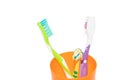 A toothbrush in a glass cup isolated on a white background. Care of teeth. Teeth cleaning. Beauty and health. Healthy teeth. Royalty Free Stock Photo