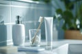 toothbrush in a glass cup with a tube of toothpaste nearby Royalty Free Stock Photo