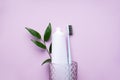 Toothbrush in a glass on a pink background, flat lay