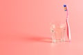 Toothbrush and a glass of water on a pink background Royalty Free Stock Photo