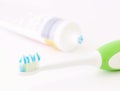 Toothbrush head with toothpaste and tube Royalty Free Stock Photo