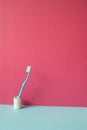 Toothbrush in holder on skyblue shelf. pink wall background Royalty Free Stock Photo