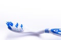 Toothbrush isolated on a white background with reflection and toothpaste. Blue plastic toothbrush. Concept of dental medicine. Royalty Free Stock Photo