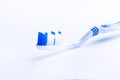 Toothbrush isolated on a white background with reflection and toothpaste. Blue plastic toothbrush. Concept of dental medicine. Royalty Free Stock Photo
