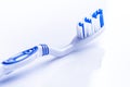 Toothbrush isolated on a white background with reflection and toothpaste. Blue plastic toothbrush. Concept of dental medicine. Royalty Free Stock Photo