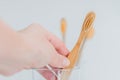 toothbrush.Teeth cleaning.Toothbrush in hand under tap water in bathroom. Hand takes a toothbrush from a transparent Royalty Free Stock Photo