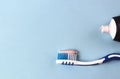 Toothbrush with toothpaste on a blue background, close-up, teeth care concept, copy space Royalty Free Stock Photo