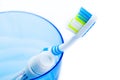 Toothbrush and toothpaste in blue plastic glass Royalty Free Stock Photo