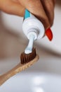 Toothbrush and toothpaste on blurred background. Closeup. Wooden toothbrush. vertical Royalty Free Stock Photo
