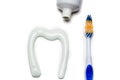 Toothbrush and toothpaste in the form of a tooth white background