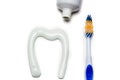 Toothbrush and toothpaste in the form of a tooth white background Royalty Free Stock Photo