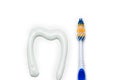 Toothbrush and toothpaste in the form of a tooth white background Royalty Free Stock Photo