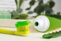 Toothbrush with toothpaste and fresh aloe leaf on white wooden table, closeup Royalty Free Stock Photo