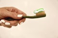 Toothbrush with toothpaste in the girl`s hand