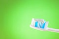Toothbrush with toothpaste on a green background with copy space Royalty Free Stock Photo