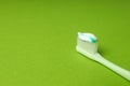 Toothbrush with toothpaste on green background, space for text Royalty Free Stock Photo