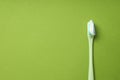Toothbrush with toothpaste on green background, space for text Royalty Free Stock Photo