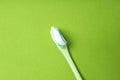 Toothbrush with toothpaste on green background, top view Royalty Free Stock Photo
