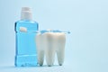 A toothbrush with toothpaste and mouthwash on blue background Royalty Free Stock Photo