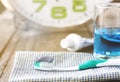 Toothbrush with toothpaste and mouthwash on wall clock background. Royalty Free Stock Photo