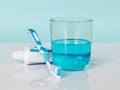 Toothbrush, toothpaste, mouthwash on a white-blue background. The concept of daily dental care Royalty Free Stock Photo