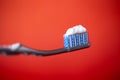 toothbrush with toothpaste on a red background Royalty Free Stock Photo