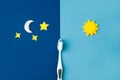 Toothbrush with toothpaste , Sun, moon and stars on light and dark blue background. Care about teeth in morning and evening. Daily