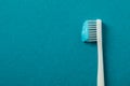 Toothbrush with toothpaste on turquoise background space for text Royalty Free Stock Photo