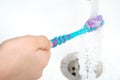 A toothbrush under running water. Close up Royalty Free Stock Photo