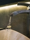 Toothbrush under running water from a steel tap Royalty Free Stock Photo