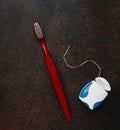 Toothbrushe and dental floss on dark background close up, with copy space Royalty Free Stock Photo