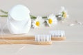 Toothbrushes, dental floss and white daisies, , closeup