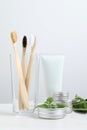 Toothbrushes, dental products and herbs on white wooden table Royalty Free Stock Photo