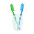 Toothbrushes in mug isolated on white background. Plastic toothbrushes in a glass holder. Transparent cup and colored brush.