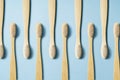 Toothbrushes regularly arranged on a blue background